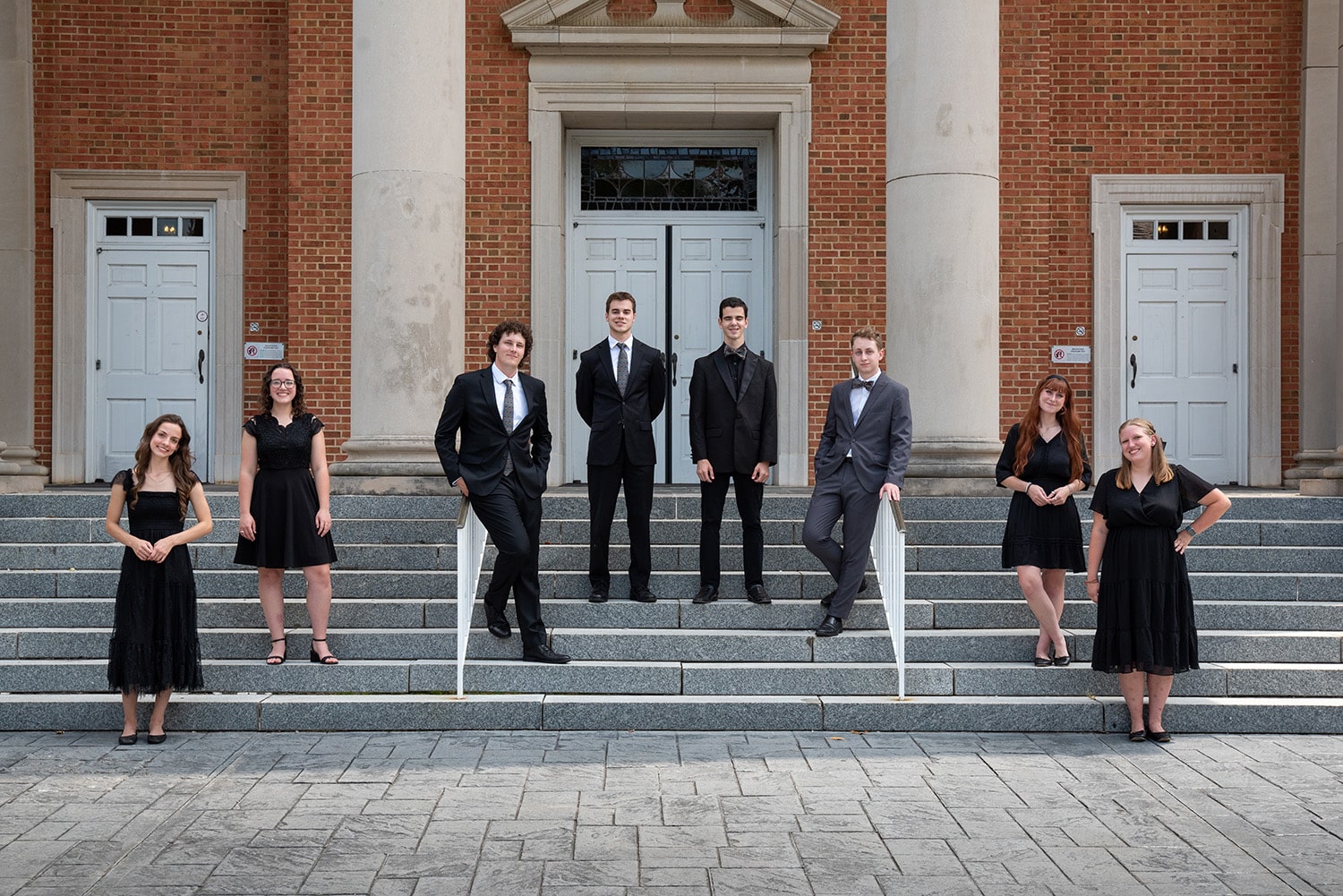 Heritage 2025 Heritage, Milligan's a cappella singing group, pose for a photo on the steps in front of Seeger Chapel