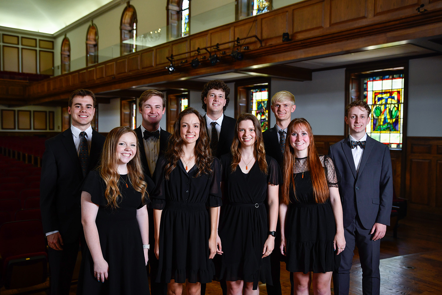 Heritage2024 members of singing group heritage pose for photo on stage in seeger chapel