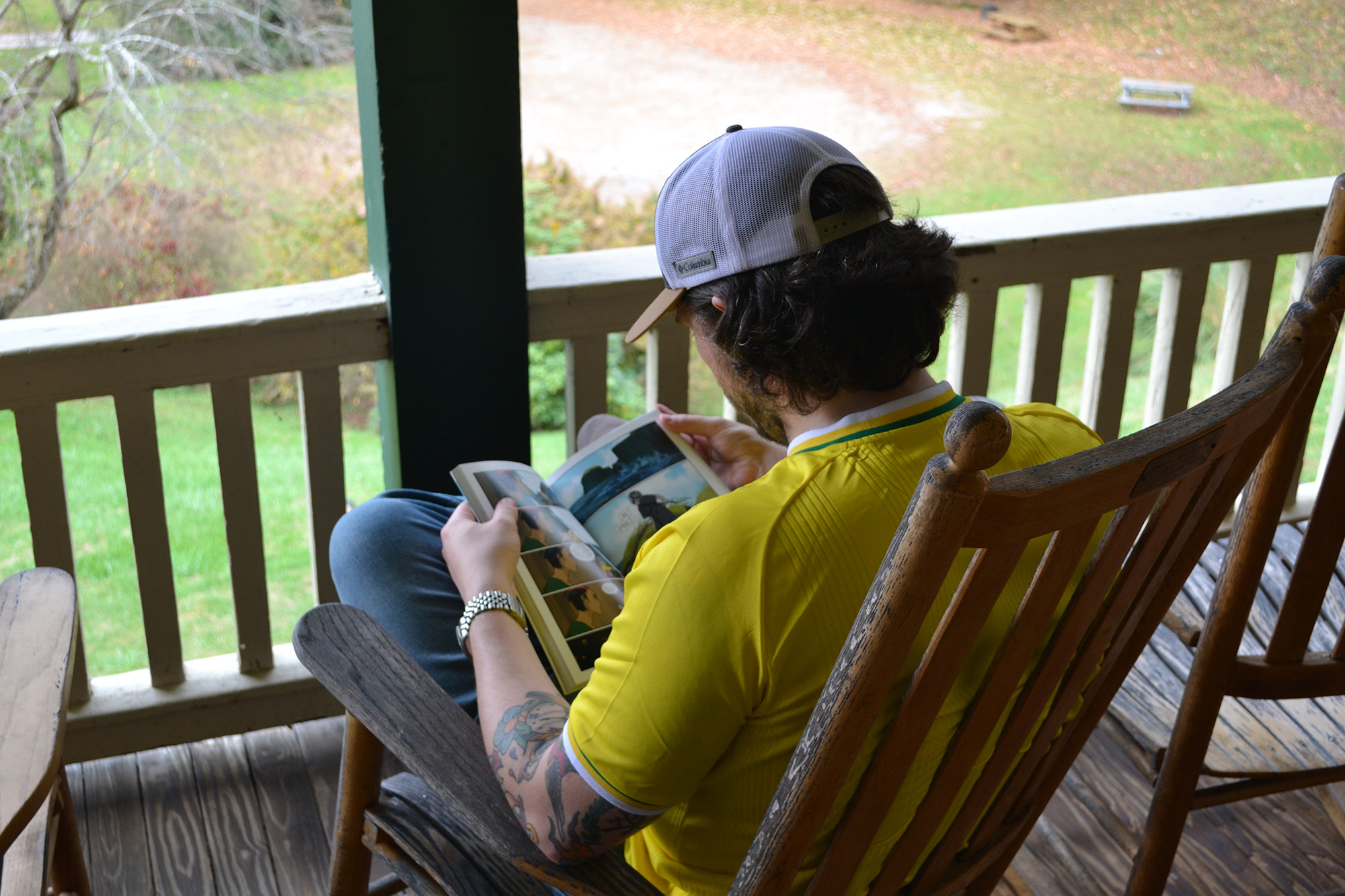 Justin Miller Justin Miller sits in nature reading during a mentoring community retreat