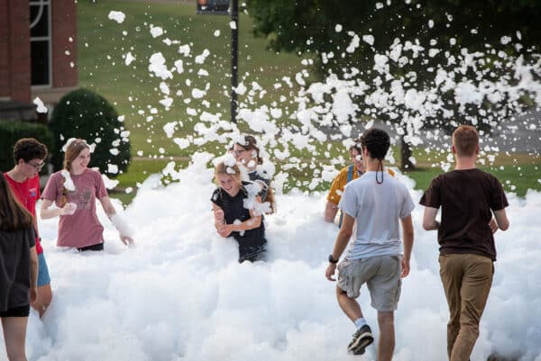 students participate in a foam party as part of welcome week activities