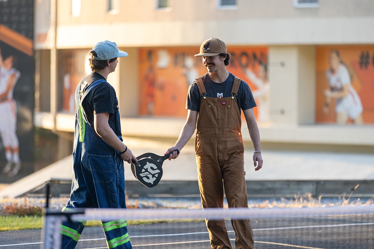 students play pickleball on courts outside of Lacy Fieldhouse